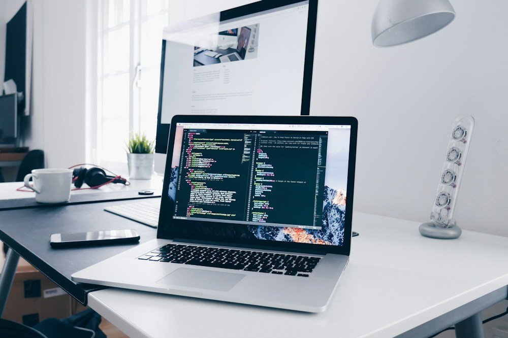 Web development code on a laptop in a design workspace